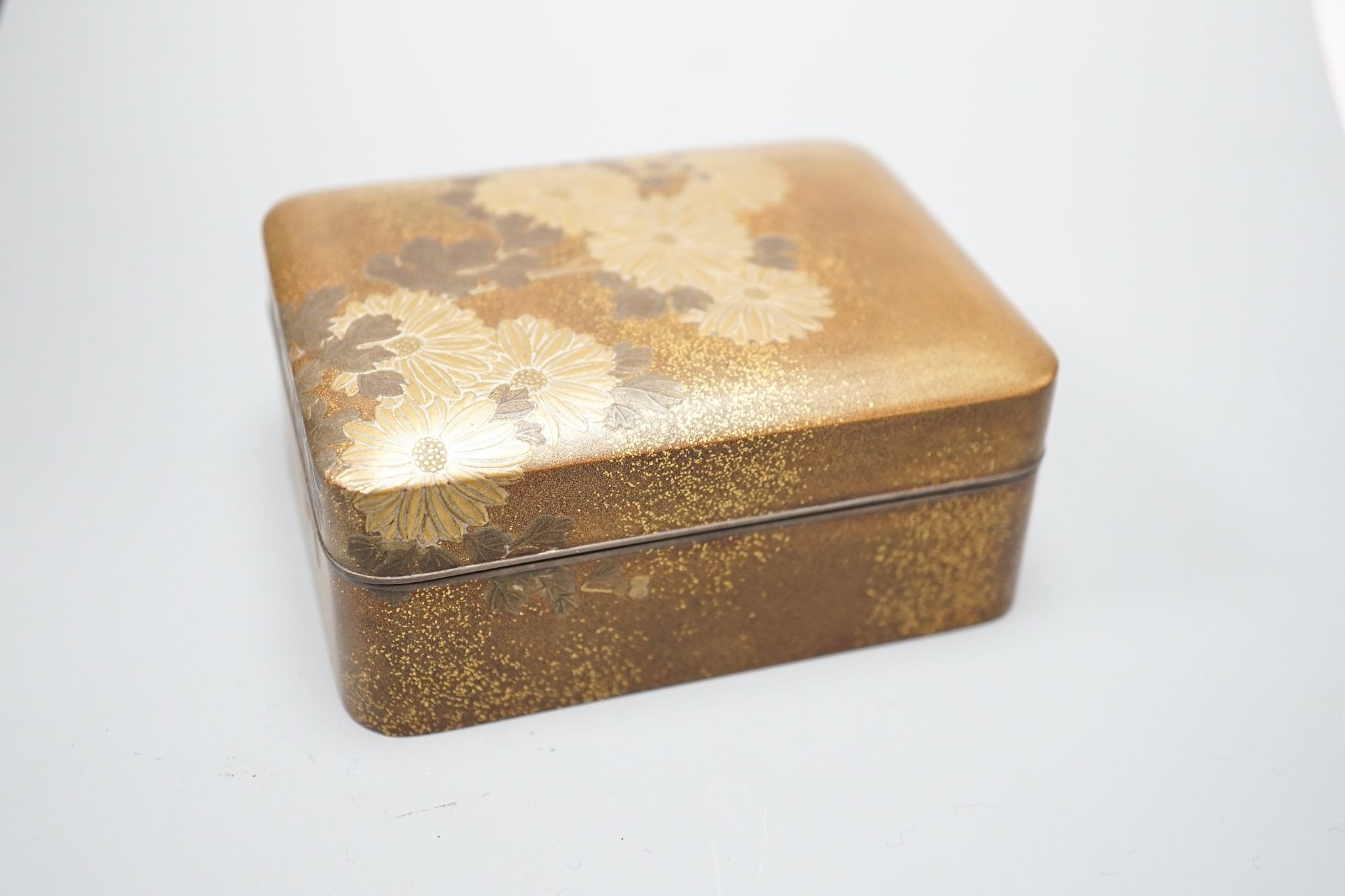 A Japanese small rectangular hiramakline (?) gold-ground box and cover decorated with chrysanthemums, 10 x 8cm